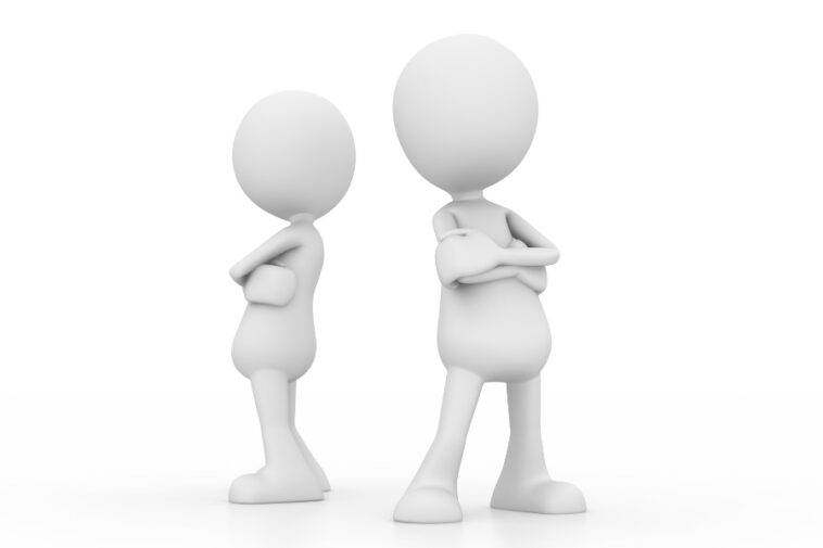 Two white faceless figures stand back to back with arms crossed against a white background.