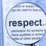 Magnifying glass focuses on the word "respect" in a dictionary entry.