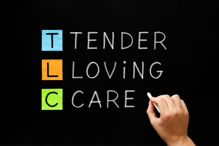 Hand writing "Tender Loving Care" on a chalkboard with colored squares next to each letter.