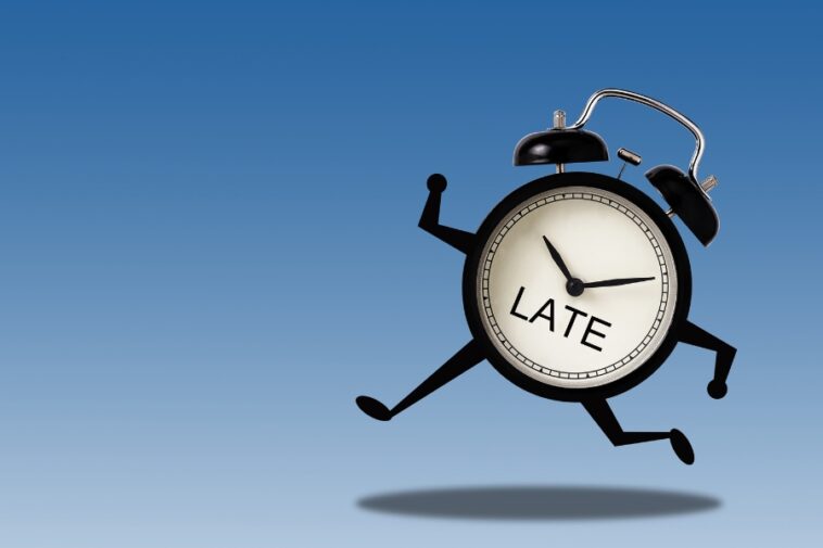 Alarm clock with arms and legs runs against a blue gradient background. The clock face reads "LATE.