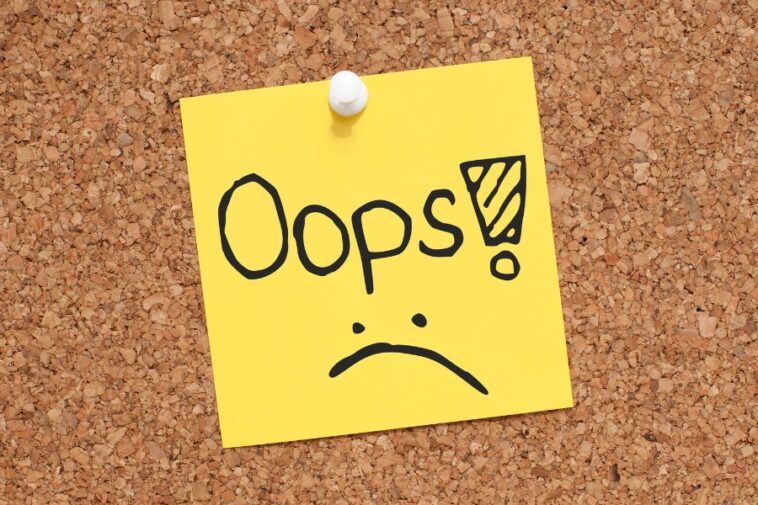 Yellow sticky note pinned to a corkboard reads "Oops!" with a sad face.