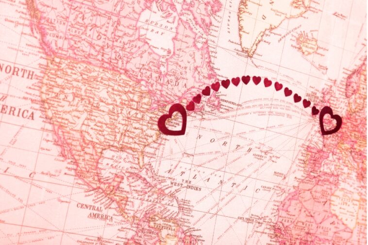 Vintage-style map showing North America and Europe, with a line of small red hearts connecting New York and the British Isles, each marked with a larger red heart.