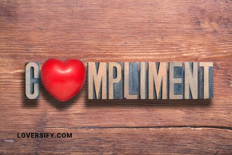 Wooden background with the word "COMPLIMENT" spelled out in block letters, with a red heart replacing the "O".