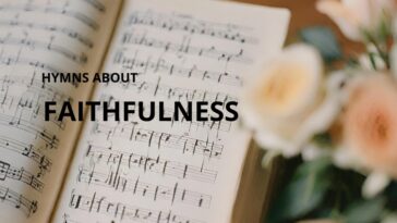 Open hymn book with musical notes and text "Hymns About Faithfulness," next to blurred peach and white roses.