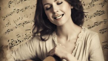 A smiling woman with closed eyes holds a guitar, with musical notes in the background.