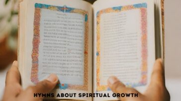 Open book held by two hands, pages filled with text and decorative borders.