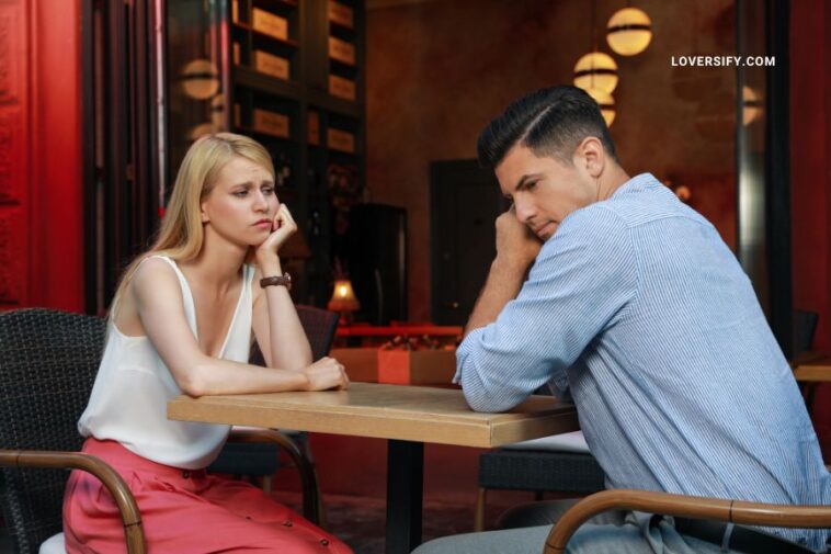 bored couple having an unsuccessful date in cafe