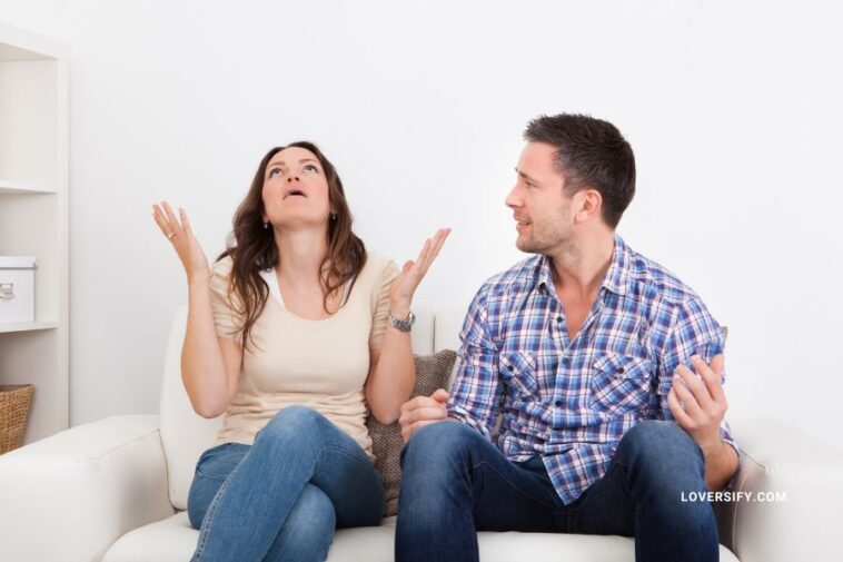 Couple sitting on a couch arguing
